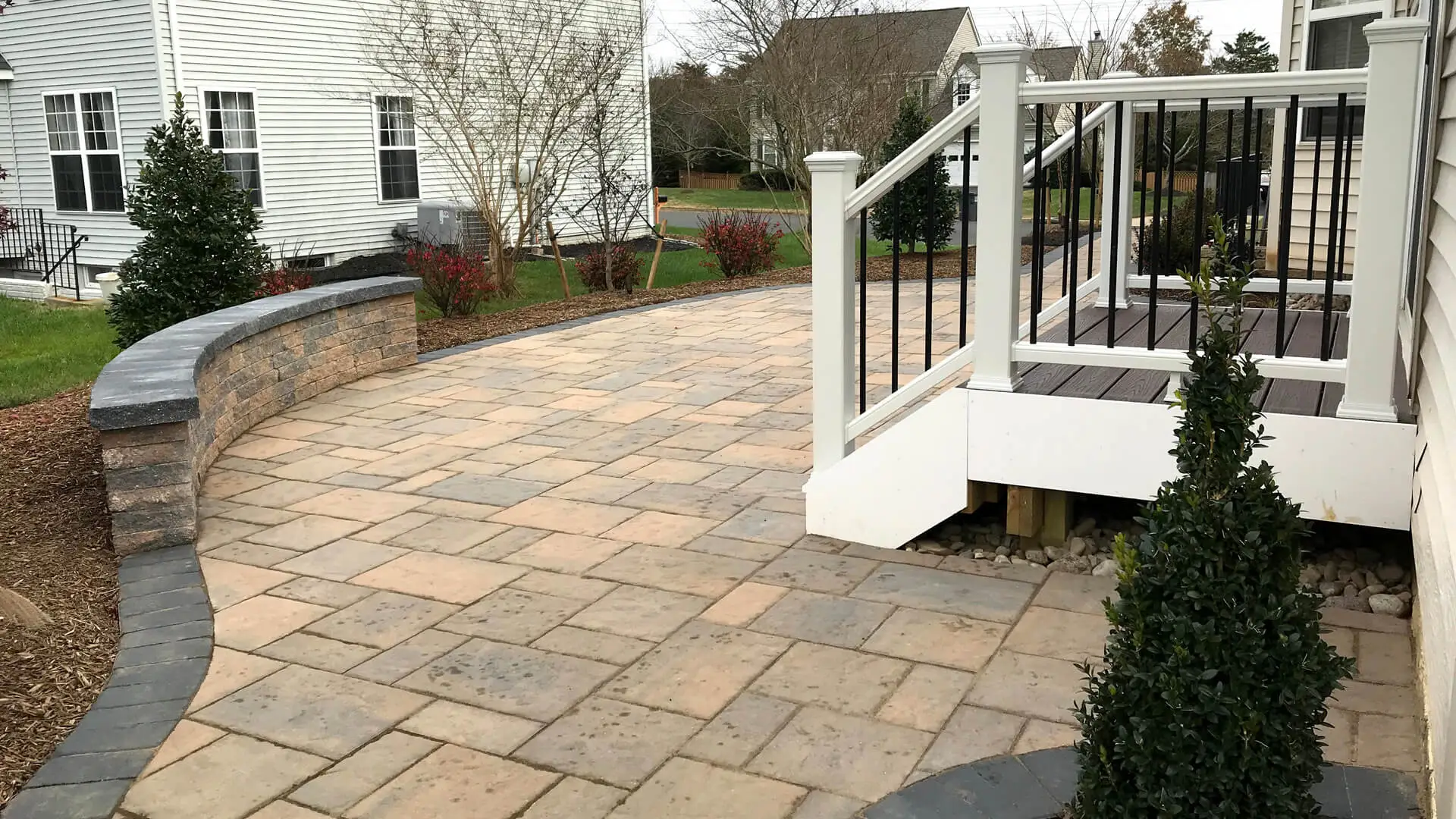 Patio on a residential property in Bristow, VA, with a seating wall.